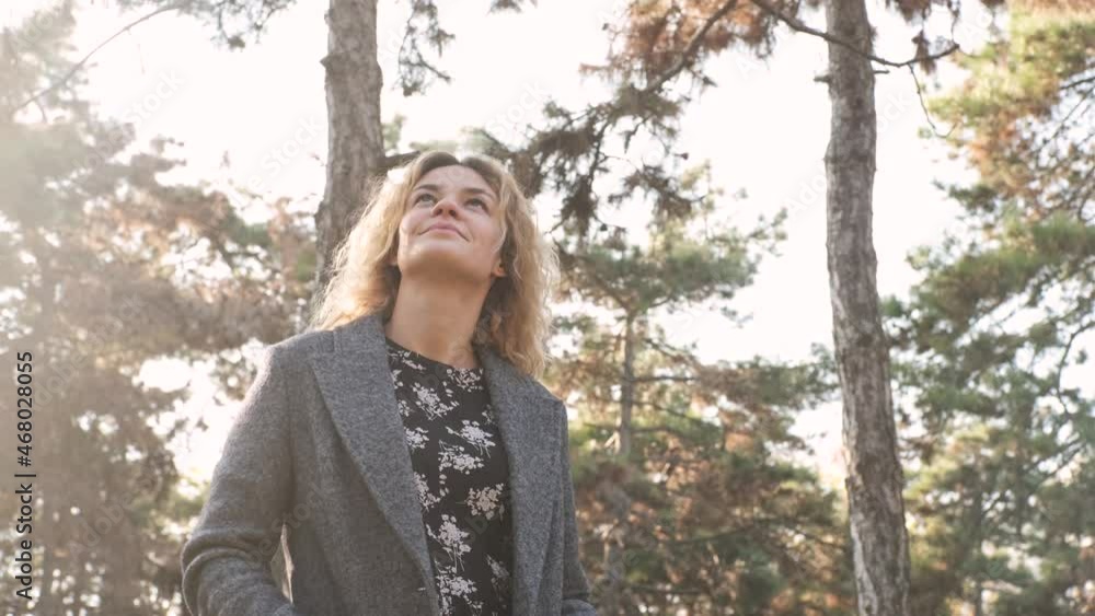 Portrait of young attractive curly woman walking in the autumn park on a sunny day Portrait of young attractive curly woman walking in the autumn park on a sunny day