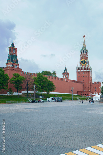 view from Red Square to the Kremlin Spasskaya Tower and St. Basil's Cathedral against the background of a cloudy sky. Moscow. Russia
