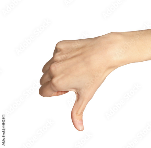 female hand makes thumbs down dislike gesture isolated on white background