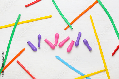 Beautiful balloons on light wooden background © Pixel-Shot