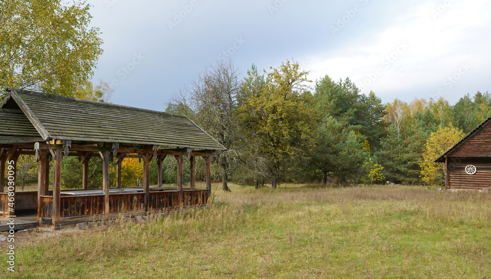 Autumn day. A summer porch and a rural barn against a background of yellowing trees. Autumn day. A summer porch and a rural barn against a background of yellowing trees.