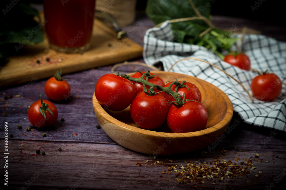 cherry tomatoes and tomato juice on a black background. Tomato cocktail with tomatoes cherry tomatoes and tomato juice on a black background. Tomato cocktail with tomatoes