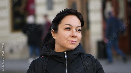 Street portrait of a smiling 40-year-old woman wea photo