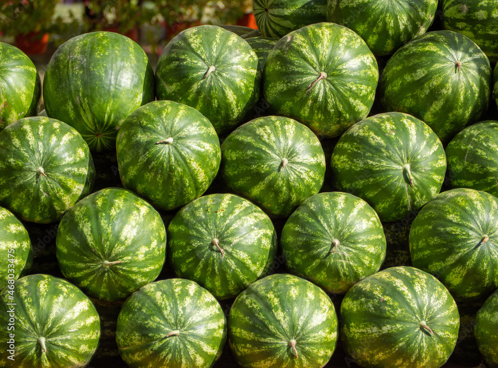 Fototapeta premium Fresh green watermelons stacked on top of each other