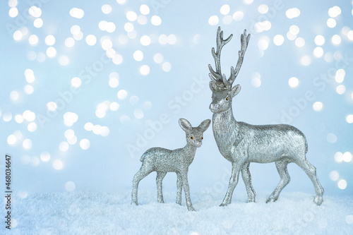 Christmas image with silver reindeers on bokeh background