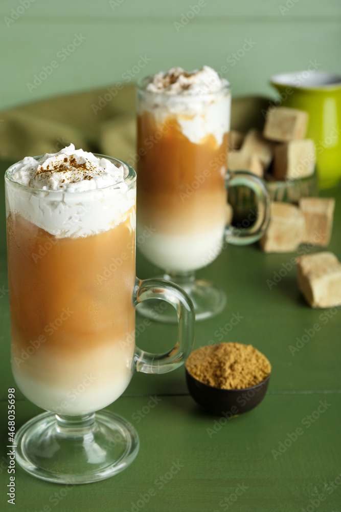 Glass cups of iced hojicha latte on table Glass cups of iced hojicha latte on table