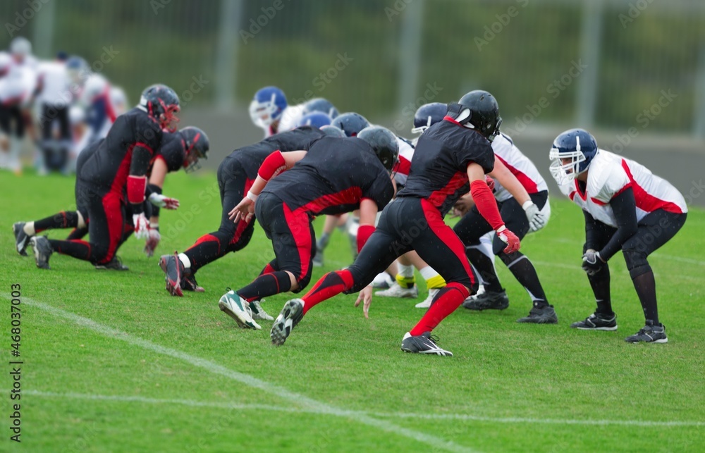 People Playing American Football on a green stadium People Playing American Football on a green stadium
