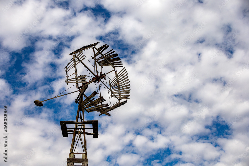 Old Windmill Against a Blue Sky with Clouds