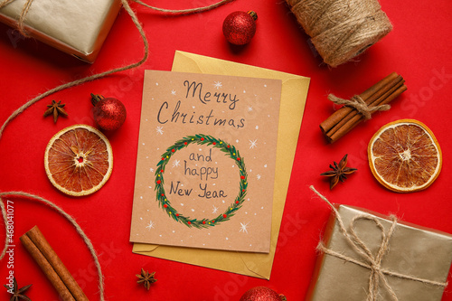 Gifts, greeting card with text MERRY CHRISTMAS AND HAPPY NEW YEAR on red background