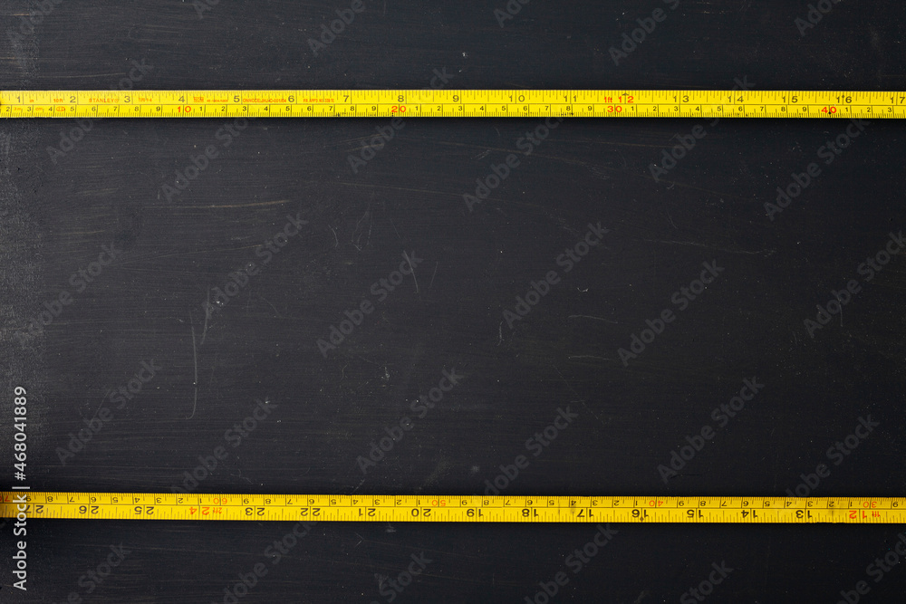 yellow measuring tape on black background