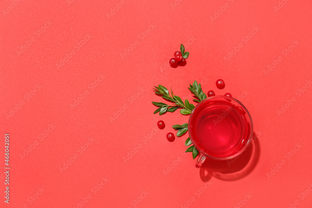 Cup of tasty lingonberry tea on red background Cup of tasty lingonberry tea on red background