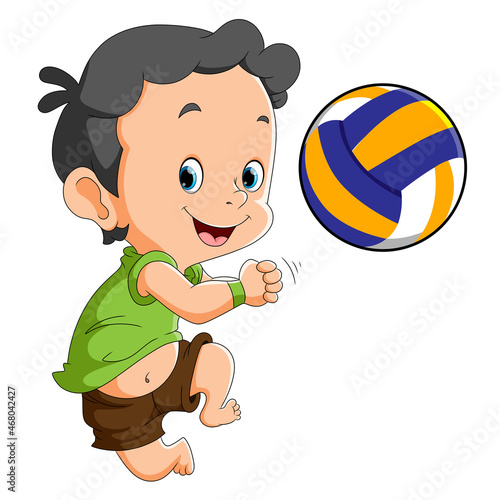 The happy boy is playing the volley ball