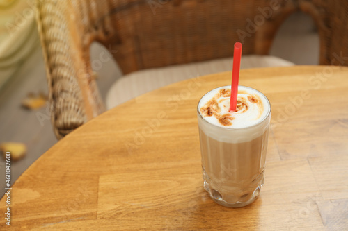 Glass of tasty coffee on table in outdoor cafe