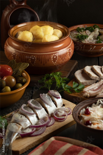 Festive table in the Russian village. Table set for dinner with traditional snacks and dishs of Russian cuisine. Vertical image.