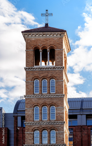 Old church steeple cross and bell tower in the city photo