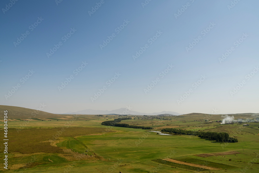 Panoramic aerial view, landscape with green hills and mountains.