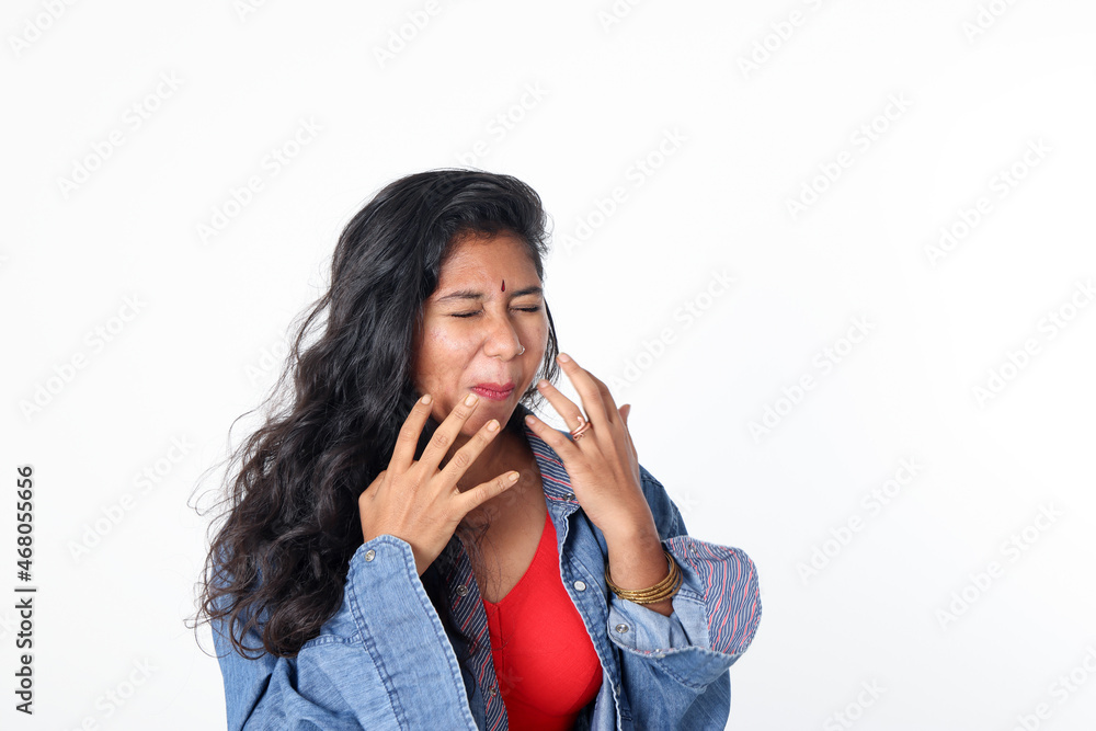 Young attractive Asian Indian woman pose face body expression mode emotion on white background pain disgust tooth ace Young attractive Asian Indian woman pose face body expression mode emotion on white background pain disgust tooth ace