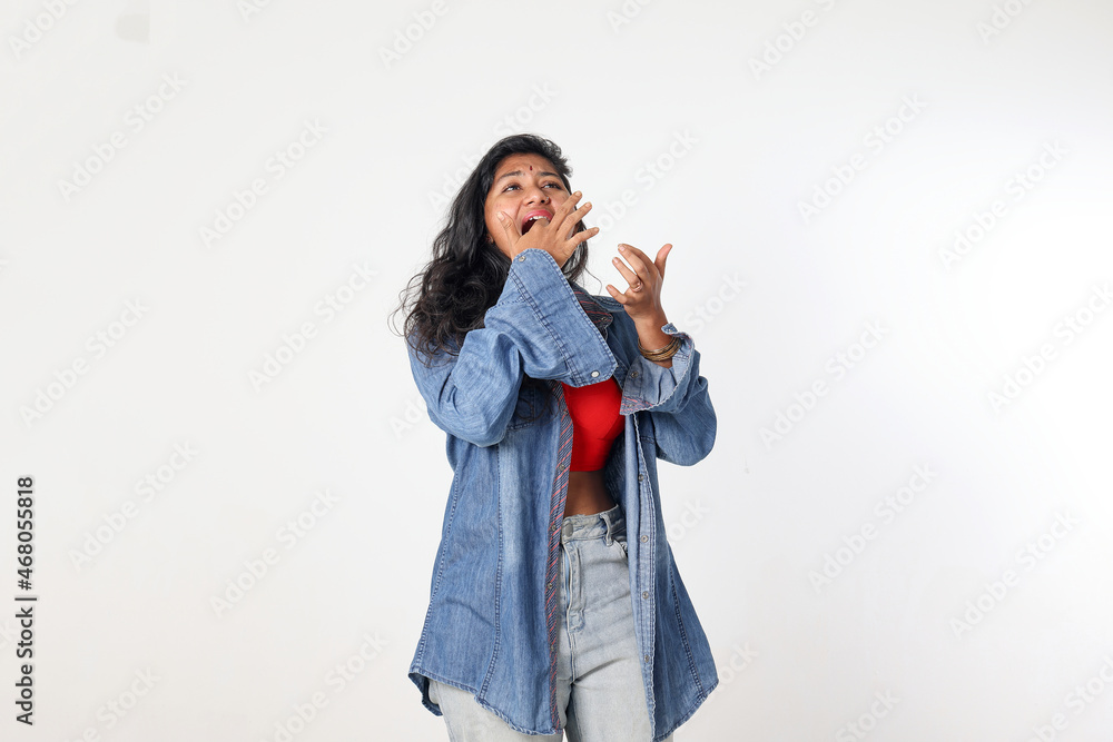 Young attractive Asian Indian woman pose face body expression mode emotion on white background standing stuck in tooth ace Young attractive Asian Indian woman pose face body expression mode emotion on white background standing stuck in tooth ace