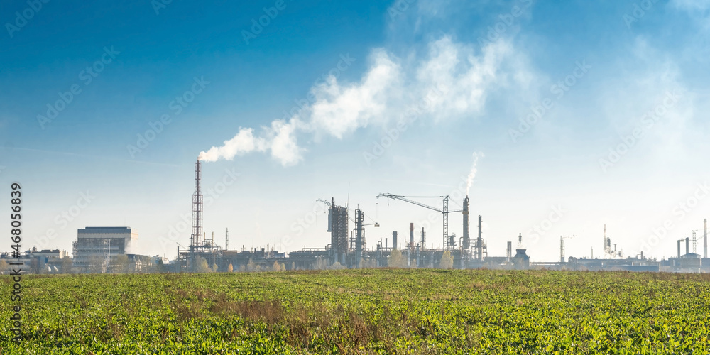 Obraz premium Industrial landscape environmental pollution waste of thermal power plant. Big pipes of chemical industry enterprise plant