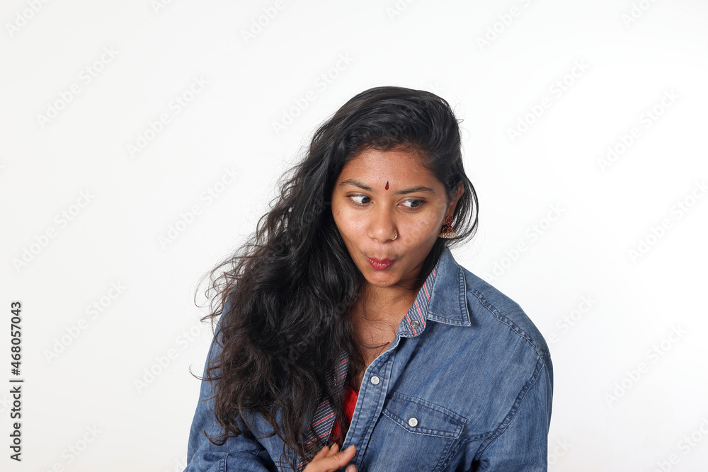 Young attractive Asian Indian woman pose face body expression mode emotion on white background shocked surprised look down Young attractive Asian Indian woman pose face body expression mode emotion on white background shocked surprised look down