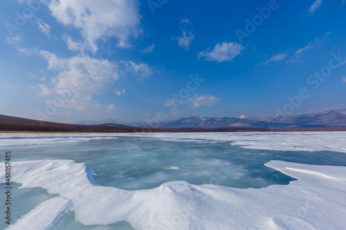 Beautiful ice of a frozen lake. Overall plan. Sikhote-Alin Biosphere Reserve in the Primorsky Territory. photo