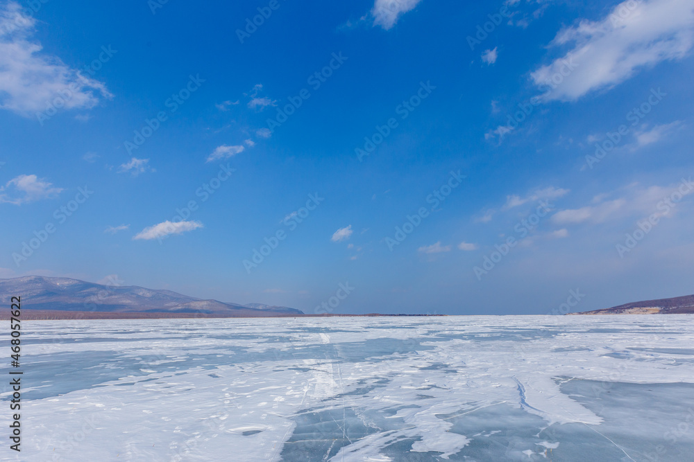 Beautiful ice of a frozen lake. Overall plan. Sikhote-Alin Biosphere Reserve in the Primorsky Territory. Beautiful ice of a frozen lake. Overall plan. Sikhote-Alin Biosphere Reserve in the Primorsky Territory.