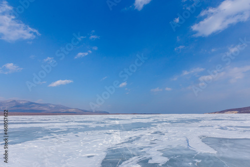 Beautiful ice of a frozen lake. Overall plan. Sikhote-Alin Biosphere Reserve in the Primorsky Territory. © alexhitrov
