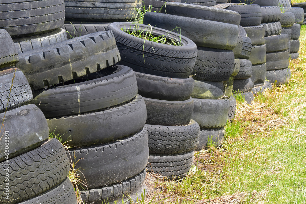 Tyre dump. Piles of waste tires and rubber tires. Old tires and wheels