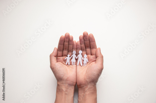 Paper family in hands isolated on white background.