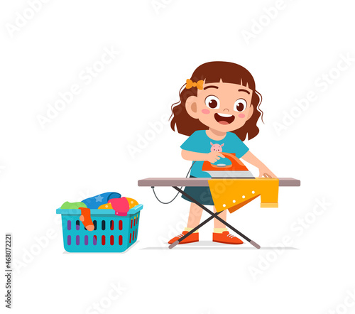 little girl use electric iron to smooth clothes