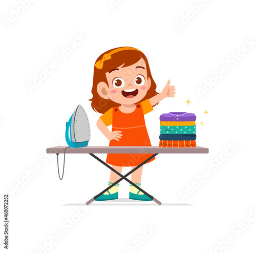 little girl use electric iron to smooth clothes