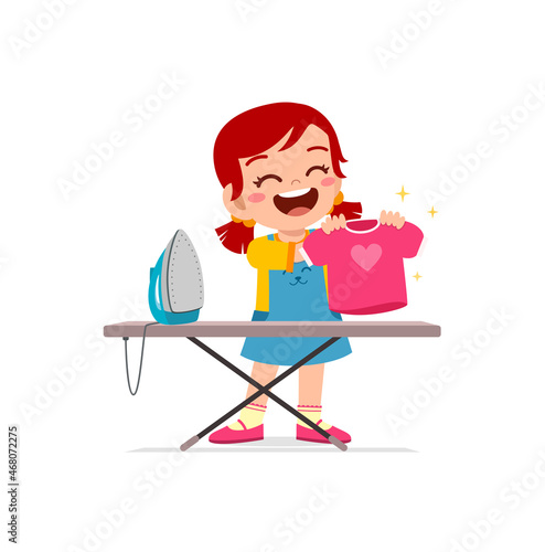 little girl use electric iron to smooth clothes