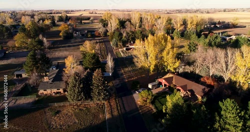 Flight over a rural road showing beautiful fall trees during sunset near Fort Collins Colorado photo