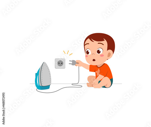 little baby curious to plug in electric iron to wall outlet
