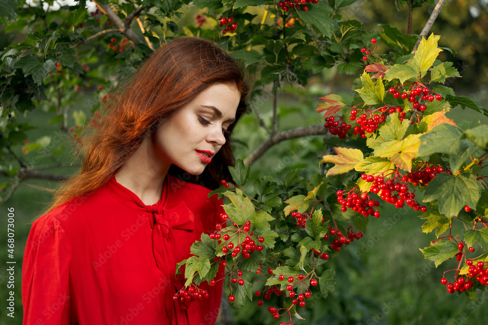 Naklejka premium cheerful woman eating berries outdoors fresh air