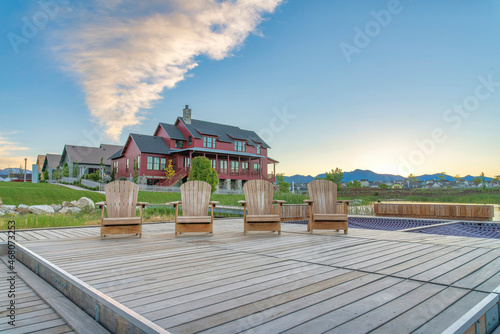 Fotografie, Tablou Wooden deck with four lounge chairs outside the residential area at Daybreak, Ut