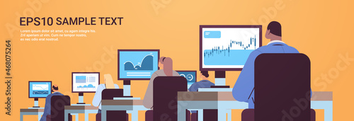 mix race traders stock market brokers analyzing charts or making presentation on computer monitors at workplace