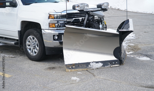 truck with snowplow in front of snow pile