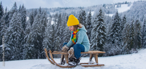 Quadro su tela Portrait of happy little kid wearing knitted hat, scarf and sweater