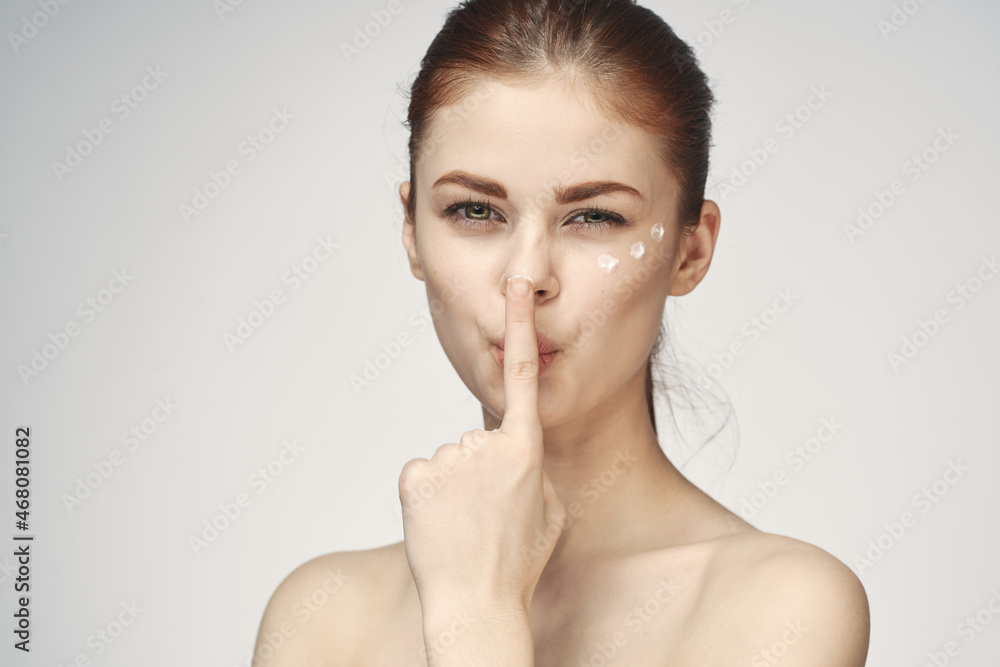 woman with bare shoulders face cream skin care close-up woman with bare shoulders face cream skin care close-up