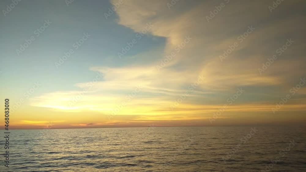 Dark calm sea and sky in the evening. Beautiful sea background, aerial view. Summer tropical sunset or sundown over the sea landscape.The sun, cloud and waves. Dark calm sea and sky in the evening. Beautiful sea background, aerial view. Summer tropical sunset or sundown over the sea landscape.The sun, cloud and waves.