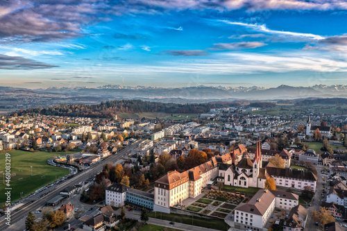 aerial view of an monastery with view of the alps 
