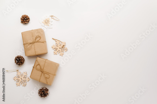 Festive background mockup for Christmas or New Year copy space. Gifts in paper eco-friendly packaging white background