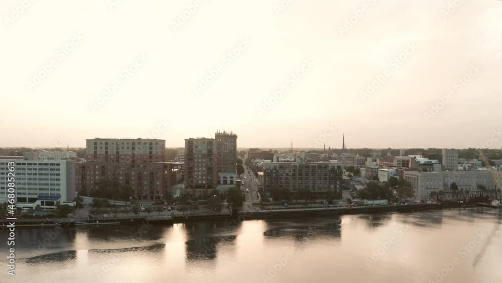 A sunrise aerial rising over the Cape Fear River reveals downtown Wilmington, North Carolina. A sunrise aerial rising over the Cape Fear River reveals downtown Wilmington, North Carolina.
