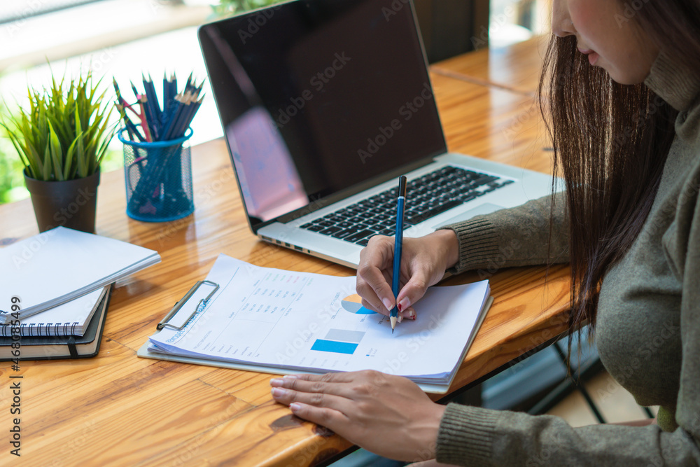 Businesswoman checking document report at co-working place. Businesswoman checking document report at co-working place.