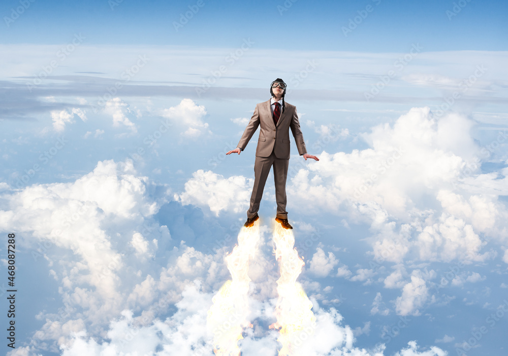 Businessman in suit and aviator hat flying in sky Businessman in suit and aviator hat flying in sky