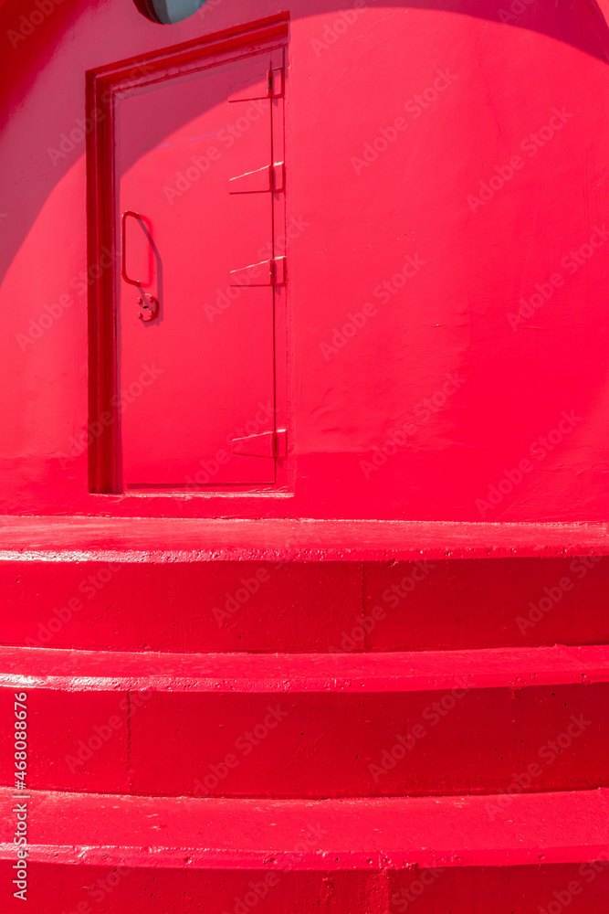 Closeup perspective view of red lighthouse door Closeup perspective view of red lighthouse door