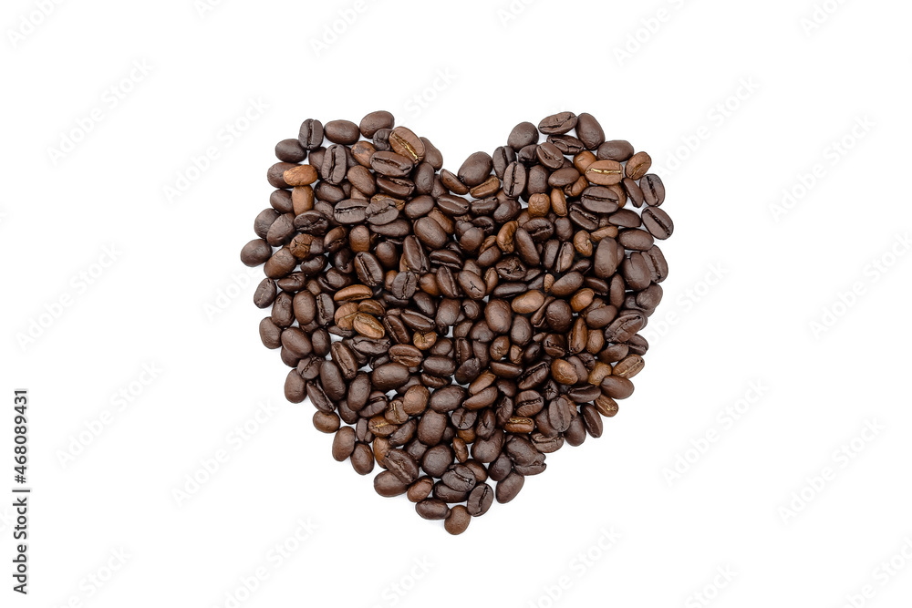 Heap of roasted coffee beans arranged in a heart shape. isolated on a white background. Heap of roasted coffee beans arranged in a heart shape. isolated on a white background.