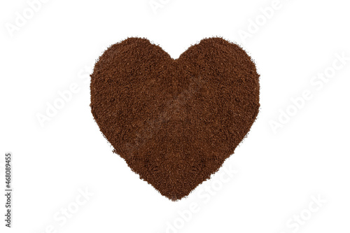 Heaps of ground roasted coffee are arranged in a heart shape. isolated on a white background.