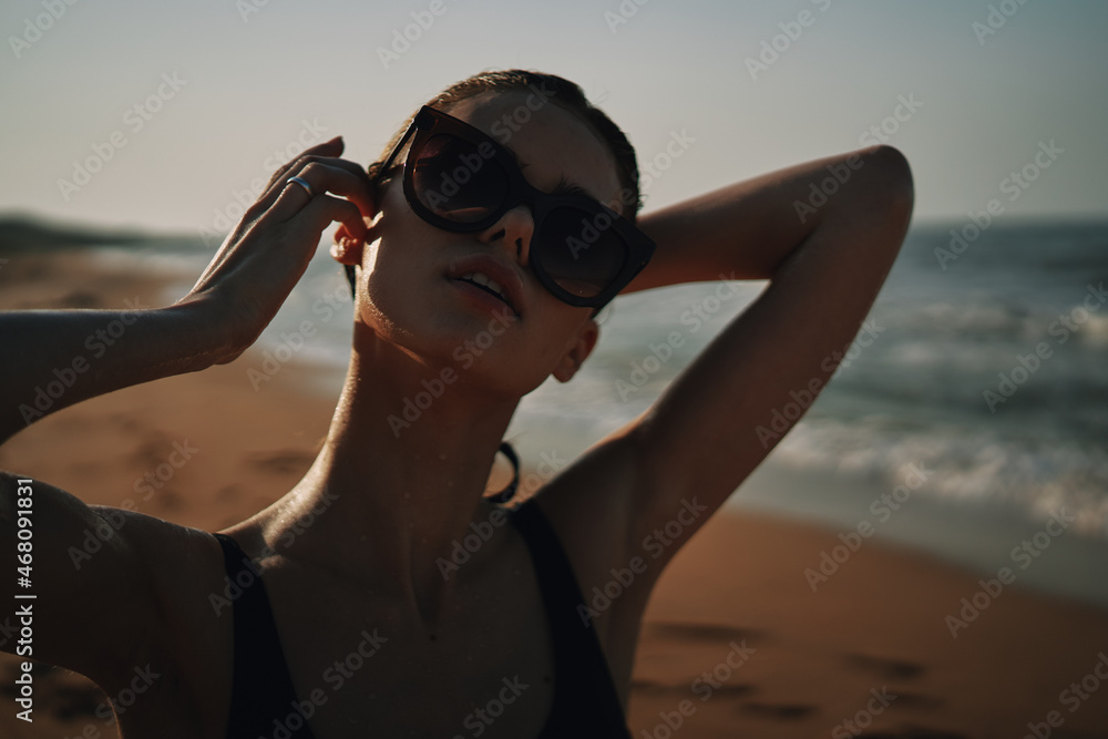 Cheerful woman black swimsuit ocean nature summer tan Cheerful woman black swimsuit ocean nature summer tan